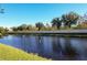 Picturesque pond with surrounding greenery and community wall at 149 Springberry Ct, Daytona Beach, FL 32124