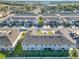 An aerial view of multiple townhouses, showcasing their backyards at 1592 Wynford Cir, Tavares, FL 32778