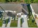 Aerial view of townhouses with landscaping and parking areas at 1592 Wynford Cir, Tavares, FL 32778