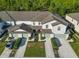 Aerial view of townhouses with garages at 1592 Wynford Cir, Tavares, FL 32778