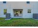 Private back patio with two chairs and AC units at 1592 Wynford Cir, Tavares, FL 32778