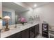 Double vanity bathroom with a large mirror and shower at 1592 Wynford Cir, Tavares, FL 32778
