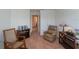 Bedroom with two rocking chairs and hallway view at 1592 Wynford Cir, Tavares, FL 32778
