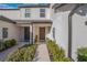 Townhome entry with walkway, landscaping, and two private entrances at 1592 Wynford Cir, Tavares, FL 32778