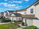 View of townhouses with a shared walkway and landscaping at 1592 Wynford Cir, Tavares, FL 32778