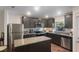 Modern kitchen with stainless steel appliances, granite counters, and island at 1592 Wynford Cir, Tavares, FL 32778