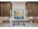 Kitchen sink with granite countertops and view to backyard at 1592 Wynford Cir, Tavares, FL 32778