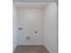 Simple laundry room with hookups and vinyl flooring at 1592 Wynford Cir, Tavares, FL 32778