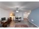 Living room with hardwood floors, ceiling fan, and access to home office at 1592 Wynford Cir, Tavares, FL 32778