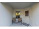 Cozy side patio with two chairs and a door at 1592 Wynford Cir, Tavares, FL 32778