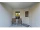 Cozy side patio with two chairs and a door at 1592 Wynford Cir, Tavares, FL 32778