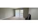 Bright bedroom with sliding glass doors leading to a balcony at 1695 Lee Rd # B216, Winter Park, FL 32789