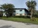 Exterior view of a light teal building with mature trees and landscaping at 1695 Lee Rd # B216, Winter Park, FL 32789