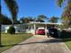 Ranch-style home with carport and landscaped lawn at 201 W Pierce Ave, Orlando, FL 32809