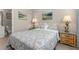 Cozy bedroom with a double bed, nightstands, and artwork at 2361 Silver Palm Dr, Kissimmee, FL 34747