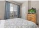 Bedroom with a double bed, dresser, and window with blinds and curtains at 2361 Silver Palm Dr, Kissimmee, FL 34747