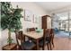 Bright dining area with a wooden table and chairs, adjacent to a patio with a pool at 2361 Silver Palm Dr, Kissimmee, FL 34747