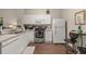 Modern kitchen with white cabinets, stainless steel appliances, and wood flooring at 2361 Silver Palm Dr, Kissimmee, FL 34747