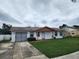 House exterior showcasing a two-car garage and a neat front yard at 248 Jalapa Dr, Kissimmee, FL 34743