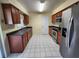 Eat-in kitchen featuring stainless steel appliances and wood cabinets at 248 Jalapa Dr, Kissimmee, FL 34743