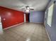 Living room featuring tile floors, two-tone walls, and ceiling fan at 248 Jalapa Dr, Kissimmee, FL 34743