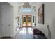 Bright and airy foyer with double doors and a modern chandelier at 2810 Lake Howell Ln, Winter Park, FL 32792