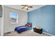 Cozy bedroom with a twin bed and blue accent wall at 4704 Homestead Trl, St Cloud, FL 34772