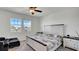 Main bedroom with plush carpet, ceiling fan, and large windows at 4704 Homestead Trl, Saint Cloud, FL 34772