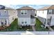 Two-story house with gray siding, light-blue door, and small front yard at 4704 Homestead Trl, St Cloud, FL 34772