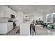 Open concept kitchen with white cabinets and stainless steel appliances at 4704 Homestead Trl, St Cloud, FL 34772