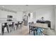 Open concept kitchen and dining area with white cabinets and stainless steel appliances at 4704 Homestead Trl, St Cloud, FL 34772