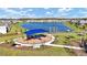 Community playground with shaded seating and lake view at 4704 Homestead Trl, St Cloud, FL 34772