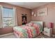 Bedroom with a colorful chevron bedspread and a peaceful atmosphere at 5420 Siltstone St, Lakeland, FL 33811