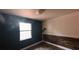 Bedroom with dark-blue accent wall and wood-look flooring at 650 East Ave, Clermont, FL 34711