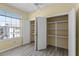 Bedroom with large window, double door closet, and wood-look floors at 7135 Yacht Basin Ave # 237, Orlando, FL 32835