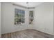Simple bedroom with wood-look flooring and large windows at 7135 Yacht Basin Ave # 237, Orlando, FL 32835