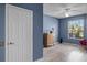 Bedroom with blue walls, wood-look flooring, and a ceiling fan at 7135 Yacht Basin Ave # 237, Orlando, FL 32835