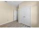 Bedroom with double door closet and wood-look floors at 7135 Yacht Basin Ave # 237, Orlando, FL 32835