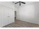 Bright bedroom with wood-look floors and double doors leading to a closet at 7135 Yacht Basin Ave # 237, Orlando, FL 32835