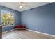 Bedroom with a window seat, red pillows, and wood-look flooring at 7135 Yacht Basin Ave # 237, Orlando, FL 32835