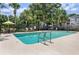 Relaxing community pool with patio furniture and umbrellas at 7135 Yacht Basin Ave # 237, Orlando, FL 32835