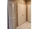 Hallway with tiled flooring, double doors, and a louvered door at 7135 Yacht Basin Ave # 237, Orlando, FL 32835