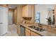 Kitchen features granite countertops, stainless steel appliances, and light wood cabinets at 7135 Yacht Basin Ave # 237, Orlando, FL 32835