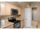 Kitchen boasts granite countertops and wood cabinets at 7135 Yacht Basin Ave # 237, Orlando, FL 32835