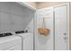 Laundry closet with washer, dryer, and shelving at 7135 Yacht Basin Ave # 237, Orlando, FL 32835