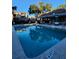 Inviting community pool with a reflection of the surrounding buildings at 7135 Yacht Basin Ave # 237, Orlando, FL 32835