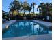 Relaxing community pool with surrounding lounge chairs and tables at 7135 Yacht Basin Ave # 237, Orlando, FL 32835