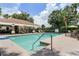 Community pool with patio area, lounge chairs, and covered seating at 7135 Yacht Basin Ave # 237, Orlando, FL 32835