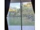 View from screened balcony overlooking a grassy area at 7135 Yacht Basin Ave # 237, Orlando, FL 32835
