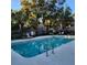 Inviting community swimming pool with lounge chairs at 7135 Yacht Basin Ave # 237, Orlando, FL 32835